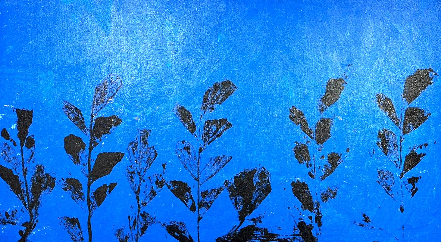 Black leaf prints rising along the bottom of a deep cobalt blue canvas
